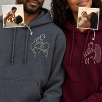 A man and a woman wearing custom printed hoodies, with inset photos of them and a child showing the source images for the custom line art designs on the gray and red hoodies.